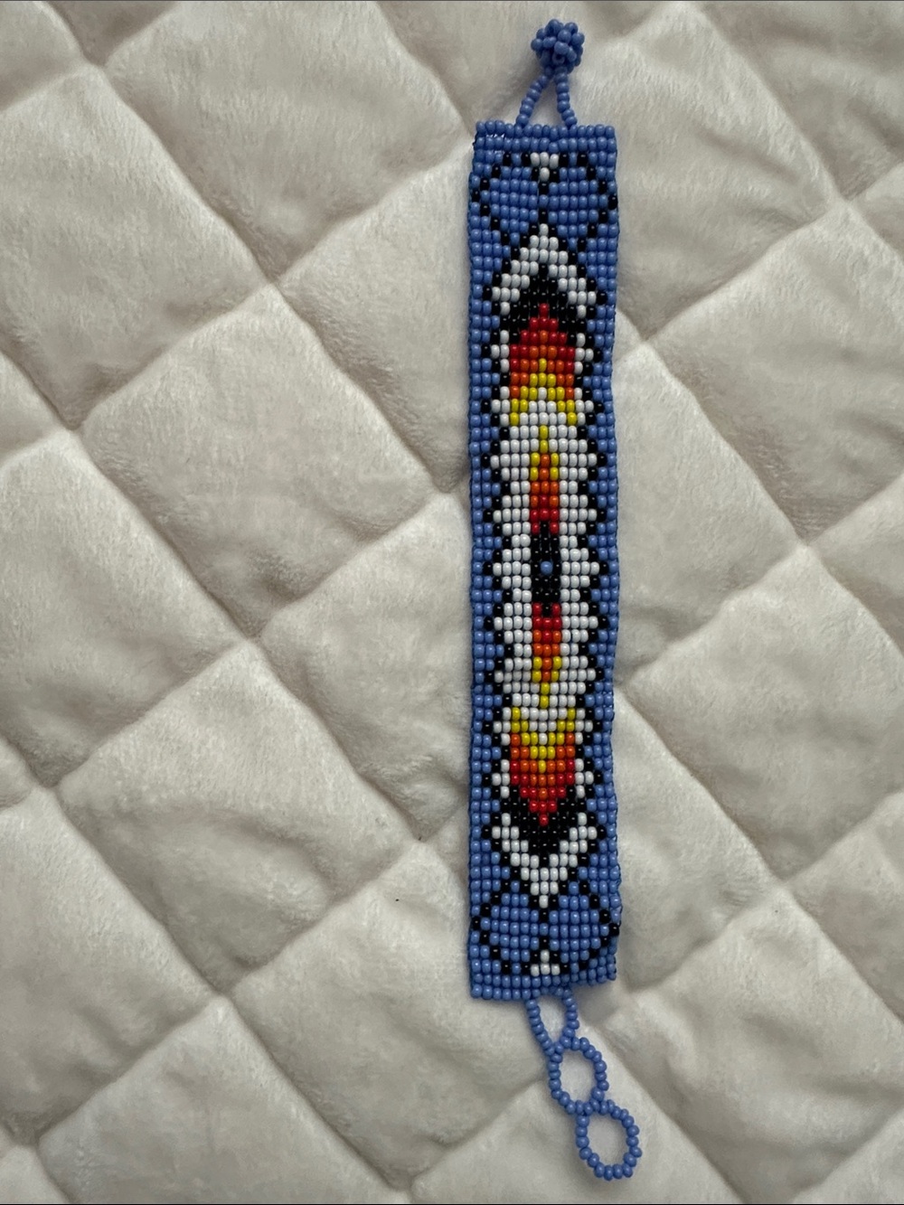 Beaded Bracelet with Blue, Red, Yellow & Black Arrow Design